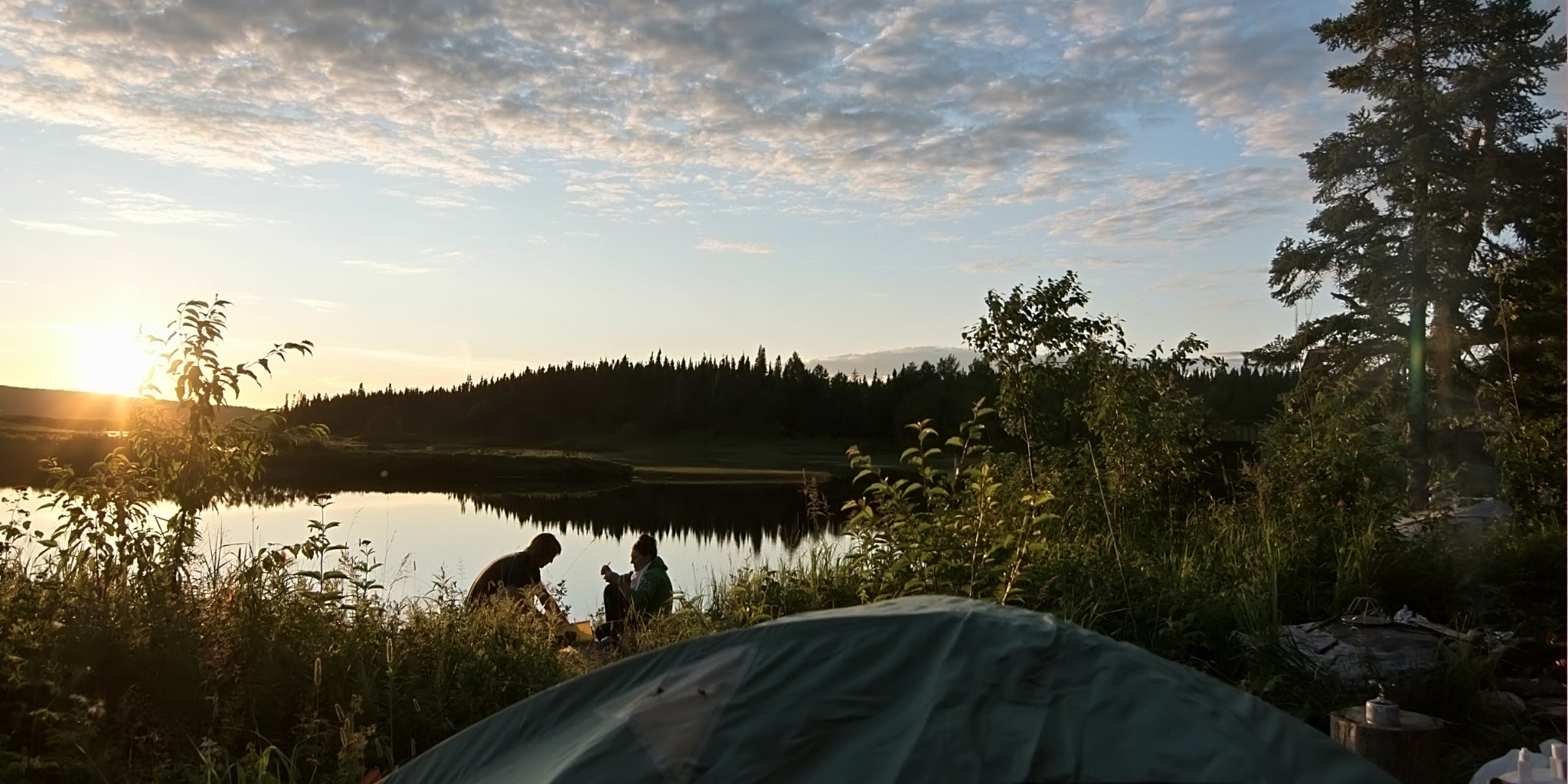 Couple en camping sur le bord la rivière Ashuapmushuan - Tente de camping sur site de campement sauvage et coucher de soleil - Koksoak Outdoor